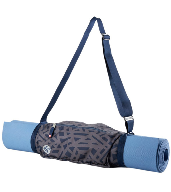 Manduka Yoga Mat Sling in "Clarity In Chaos" design, featuring a stylish geometric pattern and adjustable blue strap for easy carrying. Ideal for yoga enthusiasts seeking a convenient and fashionable way to transport their mats. Perfect for enhancing your yoga practice with style