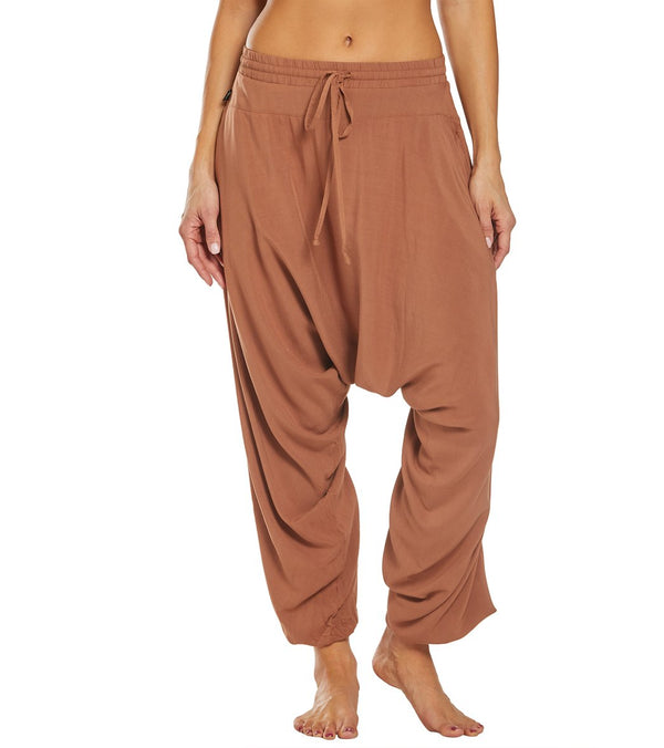 Rust-colored Buddha Pants designed for yoga, featuring a relaxed fit with a drawstring waist for comfort and flexibility. These women's yoga joggers and sweatpants offer a stylish and functional option for yoga enthusiasts. Perfect for enhancing your yoga practice with ease and style