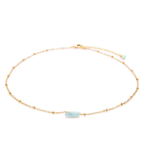 Lotus and Luna yoga necklace featuring a delicate gold chain with a single blue gemstone accent. This elegant accessory is designed for yoga enthusiasts, blending style and mindfulness. Perfect for enhancing your yoga practice with a touch of serenity and elegance.