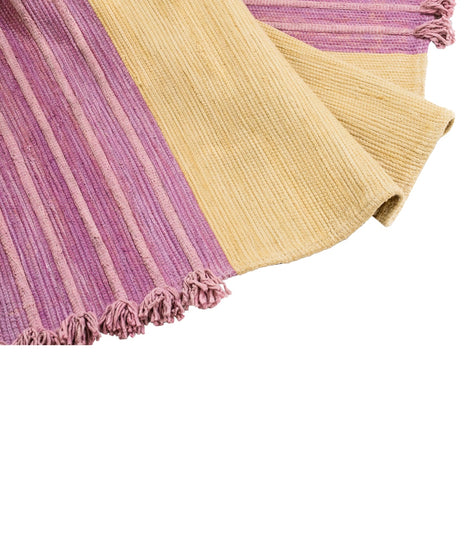 Bennd Yoga's multi-colored yoga rug features a blend of soft purple and yellow hues with textured stripes and fringed edges. This eco-friendly yoga mat is designed for enhancing your practice with natural materials. Ideal for yoga enthusiasts seeking a stylish and functional addition