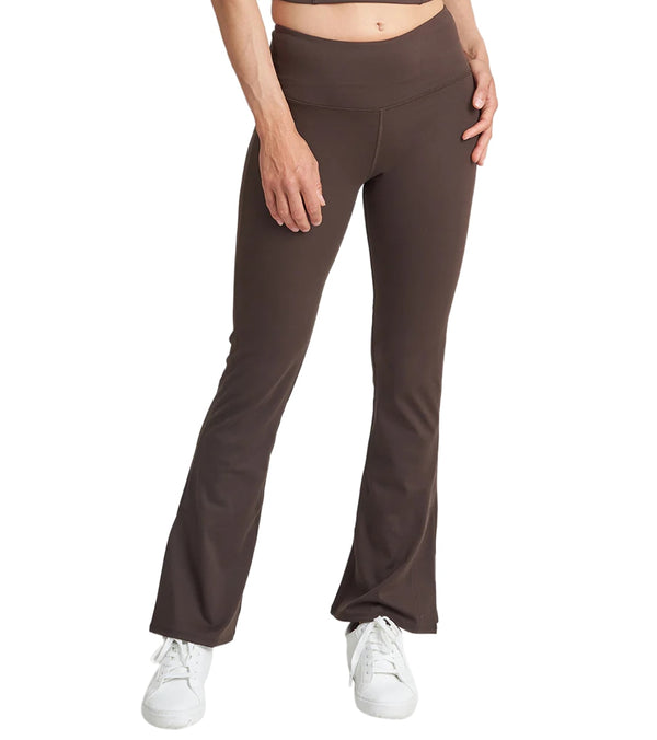 Thrive Societe Women's Flare Yoga Pants in Fudge, designed for optimal comfort and style during yoga sessions. These brown flare pants feature a high waistband for support and flexibility. Ideal for enhancing your yoga wardrobe with a chic and functional piece.