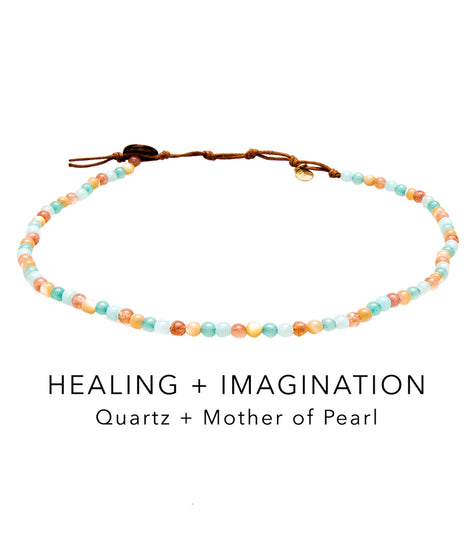 Lotus and Luna Yoga Necklace featuring Quartz and Mother of Pearl beads, designed for healing and imagination. This colorful beaded necklace is perfect for yoga enthusiasts seeking spiritual balance and style.
