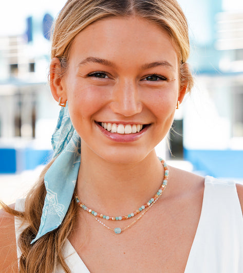 Lotus and Luna Yoga Necklace featuring Quartz and Mother of Pearl beads, designed for yoga enthusiasts. The necklace showcases a delicate arrangement of stones, perfect for enhancing mindfulness and style. Ideal for those seeking a blend of spirituality and fashion in their yoga accessories.